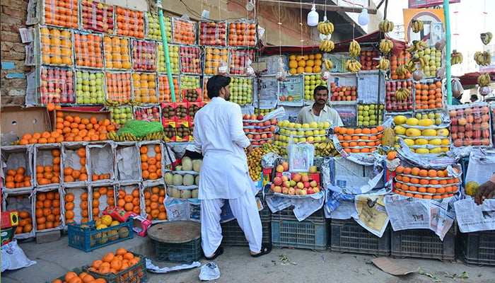 A vendor displays different fruits to attract customers at his stall in Hyderabad on February 11, 2023. — APP