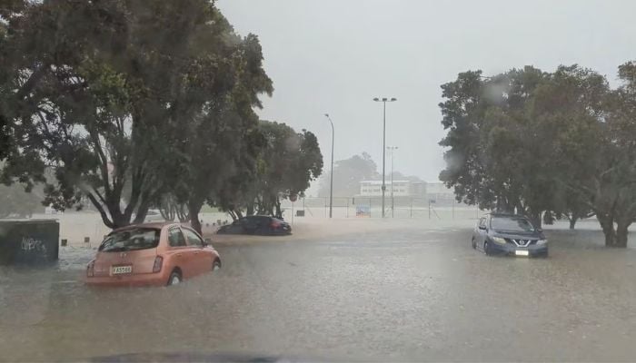 Cars are seen in a flooded street during heavy rainfall in Auckland, New Zealand January 27, 2023, in this screen grab obtained from a social media video.— Reuters