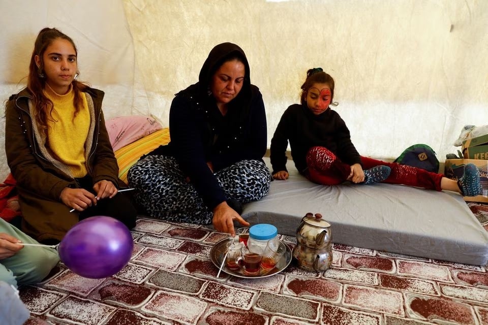 Neslihan Altinbas drinks tea in a tent, which serves as a camp for survivors, in the aftermath of the deadly earthquake in Osmaniye, Turkey February 16, 2023.— Reuters