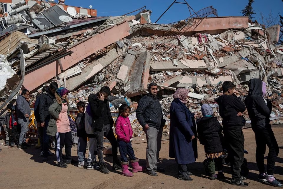 People queue for free food served amid the rubble following the deadly earthquake in Kahramanmaras, Turkey, February 16, 2023.— Reuters