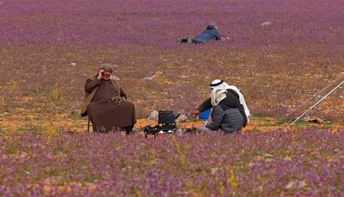 Two men prepare tea in the field in the town on February 13, 2023. — AFP