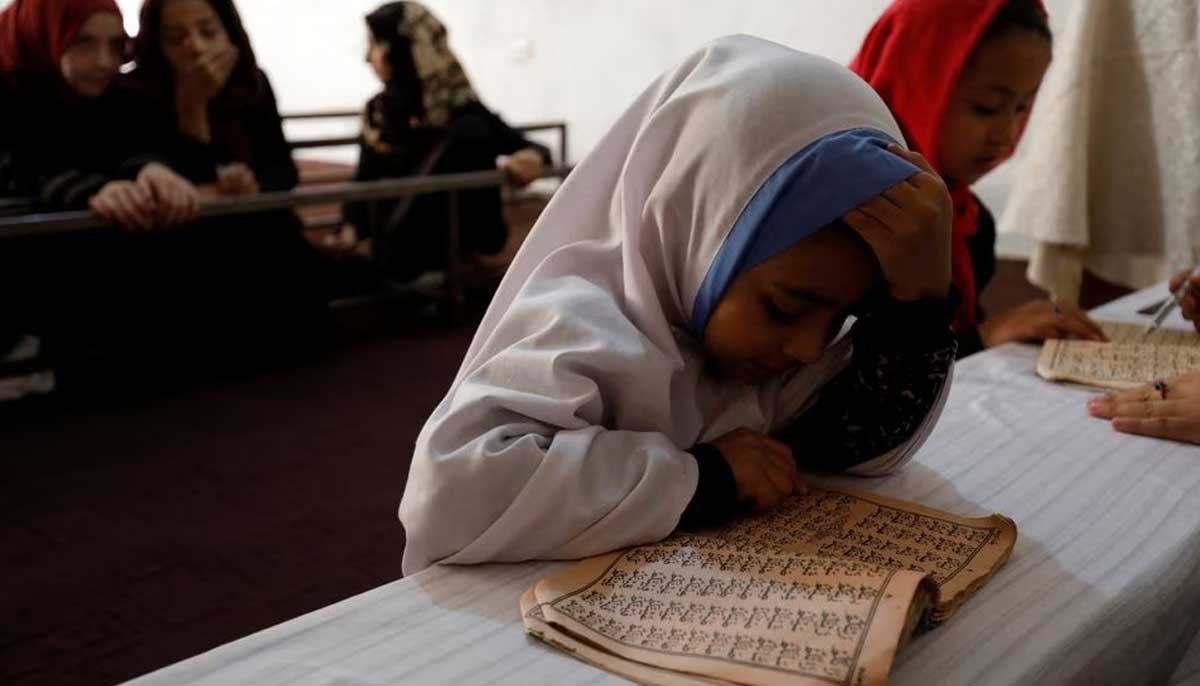 An Afghan girl reads the Holy Quran in a madrassa or religious school in Kabul, Afghanistan, October 8, 2022. — Reuters