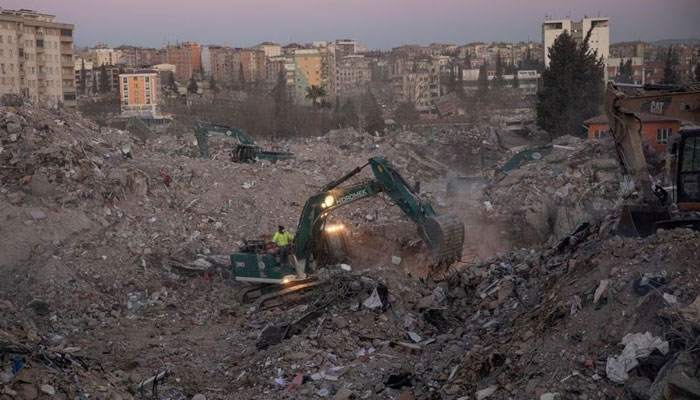 An excavator moves debris from destroyed properties following the deadly earthquake in Kahramanmaras, Turkey, February 16, 2023. Reuters