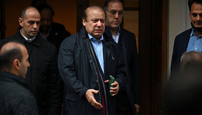 Pakistans former Prime Minister Nawaz Sharif (3L), brother of Pakistans current Prime Minister Shehbaz Sharif, leaves a property in west London on May 11, 2022. — AFP