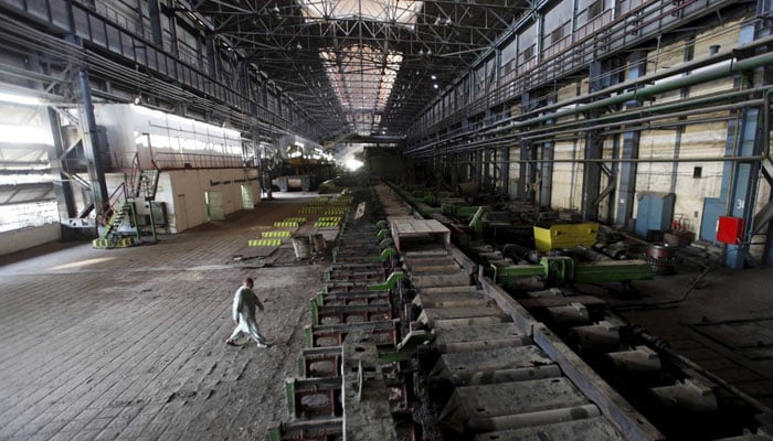 A man walks past machines at the hot strip mill department of the Pakistan Steel Mills on the outskirts of Karachi on February 8, 2016. — Reuters