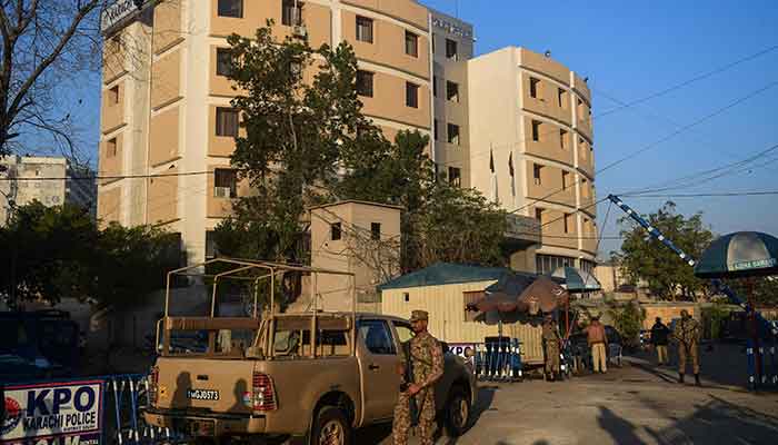 Pakistani army soldiers stand guard outside the Karachi Police Office compound on February 18, 2023. — AFP