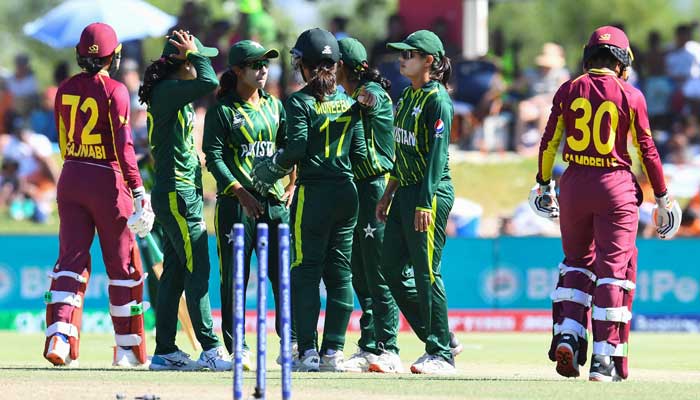 West Indies Shemaine Campbelle (right) walks back to the pavilion after being stumped out by Pakistans wicketkeeper Muneeba Ali (4th R) during the Group B T20 womens World Cup cricket match between Pakistan and West Indies at Boland Park in Paarl on February 19, 2023. — AFP