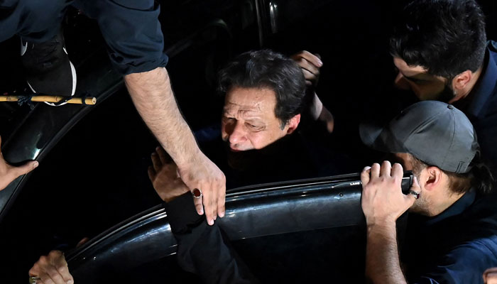 Pakistan’s ousted prime minister Imran Khan (C) arrives at high court to appear before the court for protective bail in two cases in Lahore on February 20, 2023. — AFP