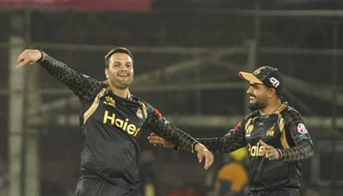 Peshawar Zalmi captain Babar Azam (right) celebrates with a teammate during the ninth match of the Pakistan Super League at the National Bank Cricket Arena in Karachi on February 20, 2023. — PSL