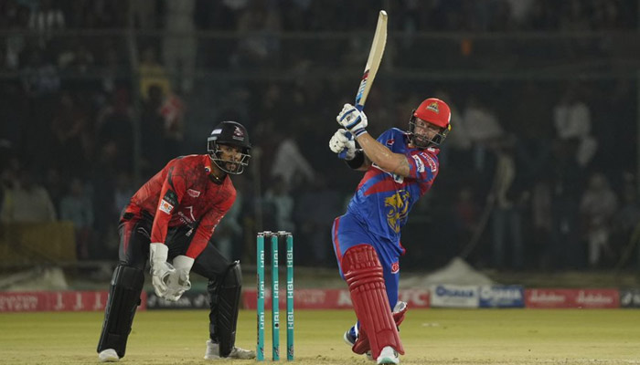 A Karachi Kings batter hits a shot as Lahore Qalandars wicketkeeper looks on during the ninth match of the Pakistan Super League in the National Bank Cricket Arena, Karachi on February 19, 2023. — PSL