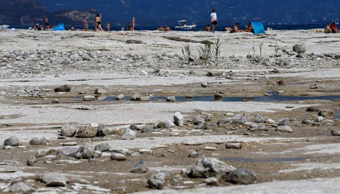 Underwater rocks emerge from the water of Lake Garda after northern Italy experienced the worst drought in 70 years in Sirmione, Italy, on August 16, 2022. —Reuters