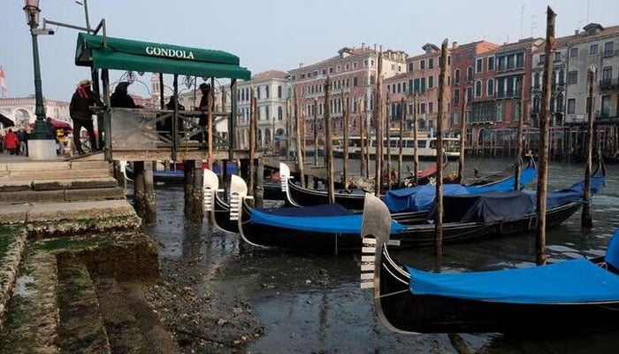 Gondolas are pictured in the Grand Canal during a severe low tide in the lagoon city of Venice, Italy, February 17, 2023. —Reuters