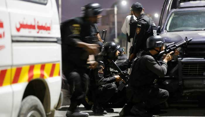 Police officers take position after an attack on a police station in Karachi, Pakistan February 17, 2023. — Reuters
