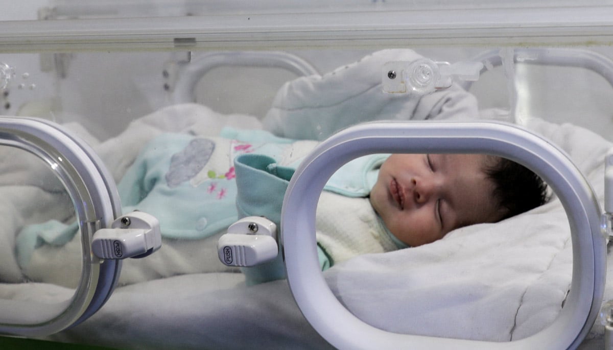 The baby girl, named Afraa after her deceased mother, lies in the Jihan Hospital in Afrin, Syria February 18, 2023. — Reuters