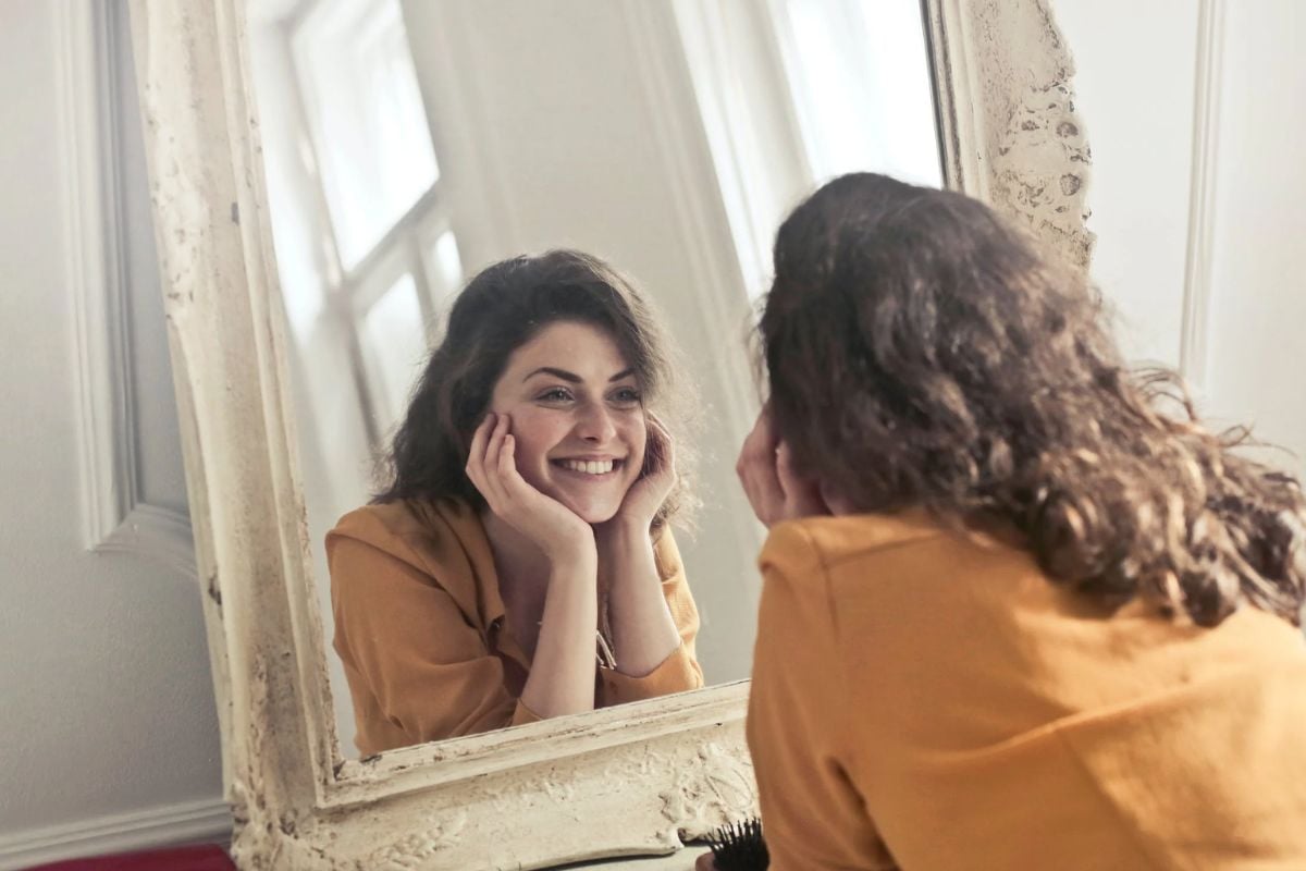 Photo of woman looking at the mirror.— Pexels