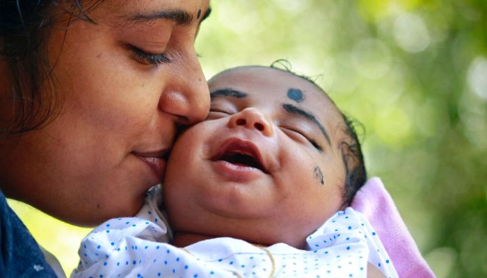 Close-op photo of a mother kissing her baby.— Pexels