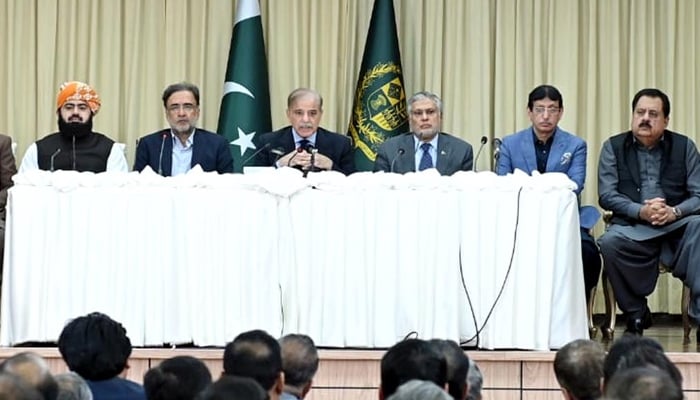 PM Shehbaz Sharif (centre) addresses a press conference in Islamabad, on February 23, 2023. — PID