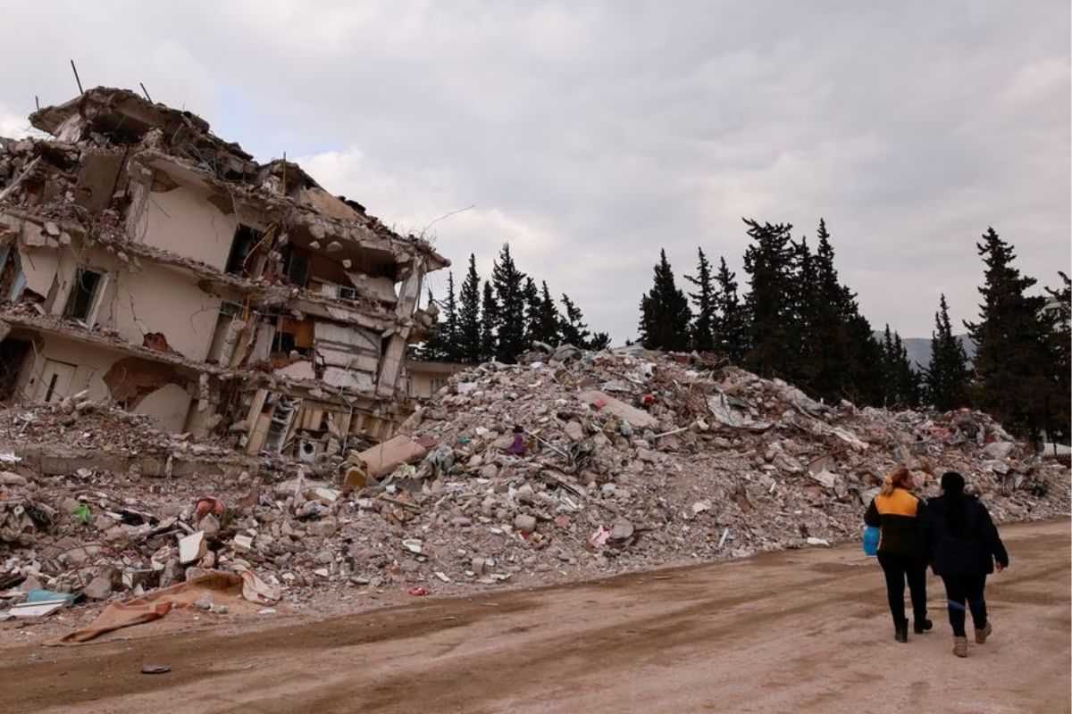 Women walk near rubble of a collapsed building in the aftermath of a deadly earthquake in Antakya, Hatay province, Turkey, February 21, 2023.— Reuters