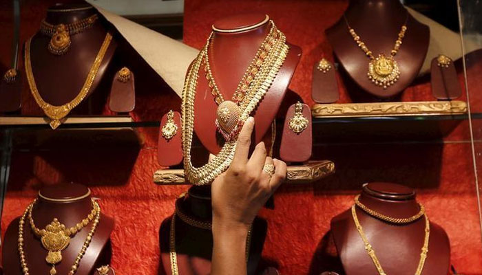 An undated image of a customer looking at the jewellery displayed at a gold store. — Reuters/File