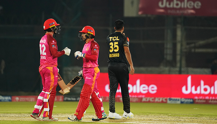 Rahmanullah Gurbaz (left) and Colin Munro bump fists during a PSL match against Peshawar Zalmi in Karachi, on February 23, 2023. — PSL