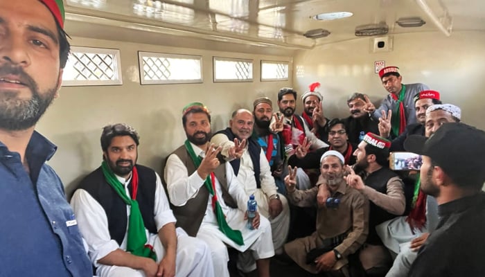 PTI workers in a police van in Peshawar, on February 23, 2023, during the partysJail Bharo Tehreek (court arrest movement). — Geo.tv/Abu Bakr Siddiqui