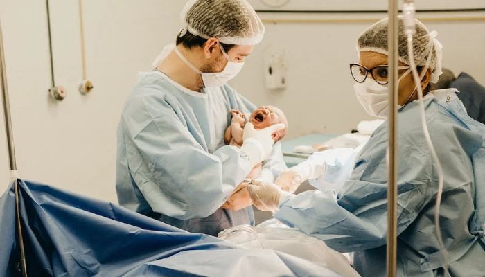 Obstetrician holds a newborn baby.— Pexels