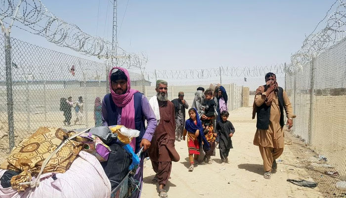 A family from Afghanistan walk next to the fence to cross into Pakistan at the Friendship Gate crossing point, in the Pakistan-Afghanistan border town of Chaman, Pakistan. — Reuters/File