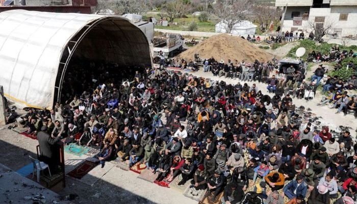 People pray outdoor during Friday prayers, after their villages mosque was destroyed in the aftermath of a deadly earthquake, in rebel-held al-Maland village, in Idlib province, Syria February 24, 2023.— Reuters