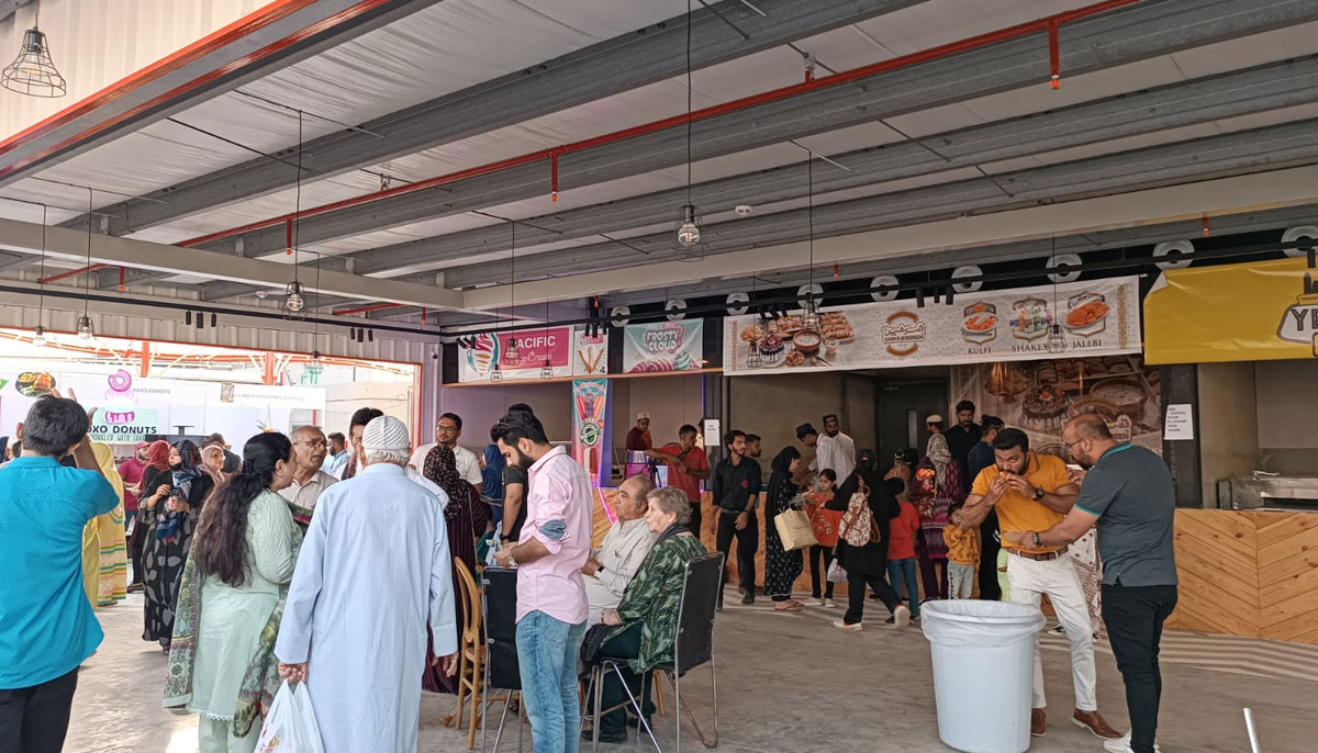 People enjoy their favourite foods on the second day of the Bohra Food Festival in Karachi. — By the author