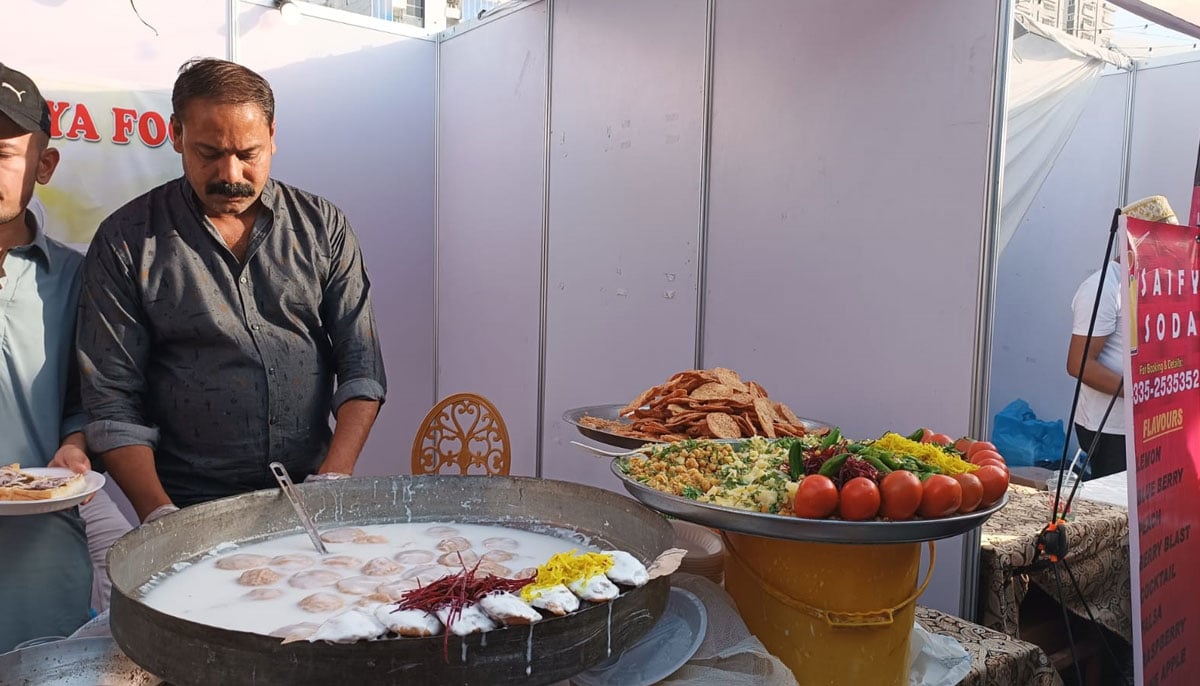 A food seller prepares a plate of a yoghurt-based chaat, for a customer during the second day of the Bohra Food Festival in Karachi on February 25, 2023. — By the author