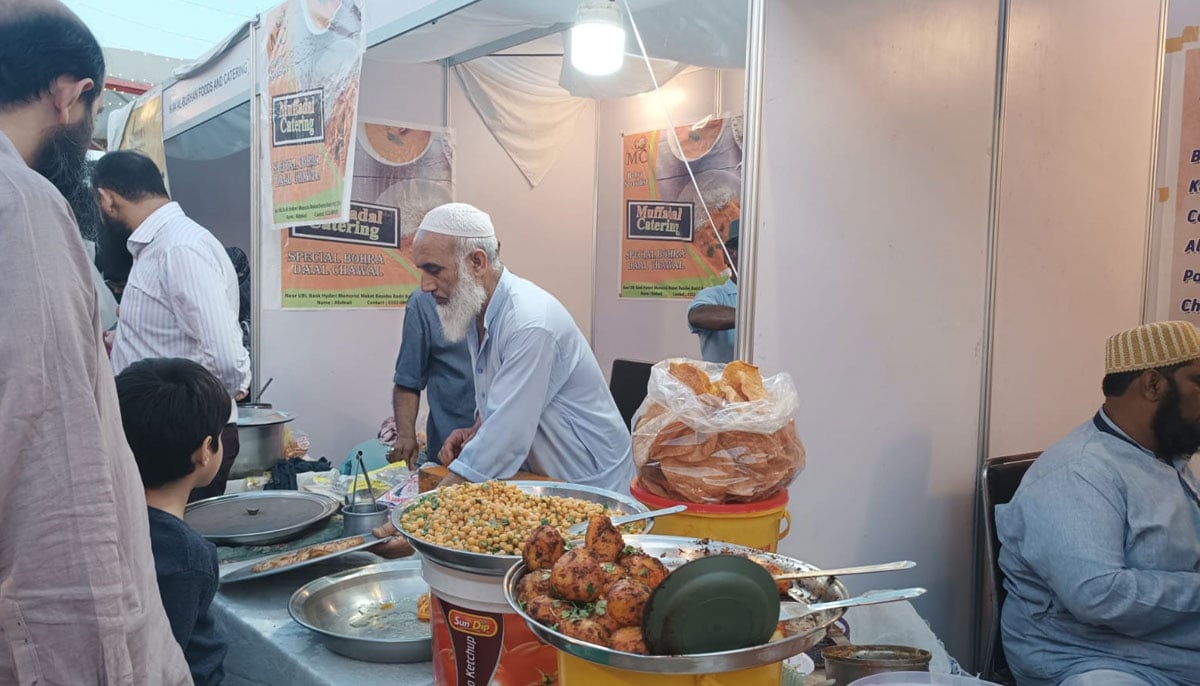 A vendor prepares food for customers during the second day of the Food Festival. — By the author