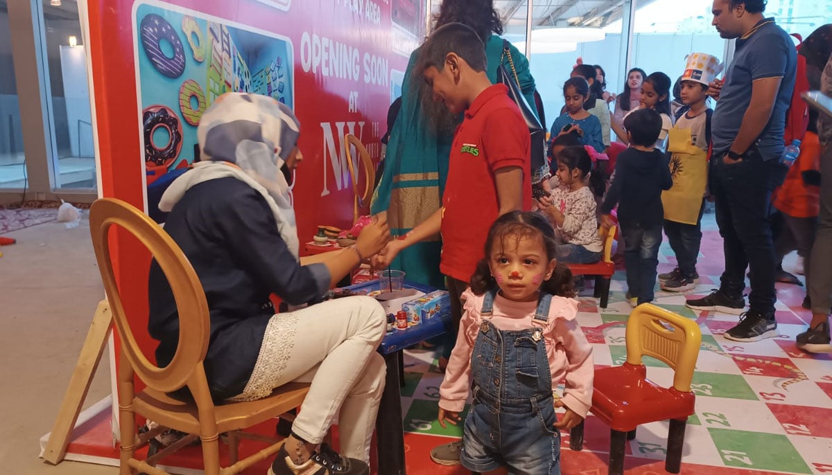 A face-painted child looks on during the second day of the Food Festival. — By the author