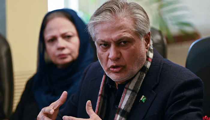 Finance Minister Ishaq Dar (R) speaks during a press conference in Islamabad on February 10, 2023. — AFP