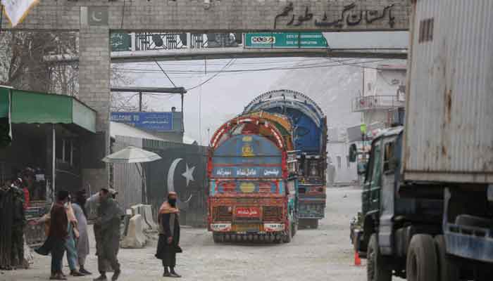 Goods carrier trucks cross into Pakistan at the zero point Torkham border crossing between Afghanistan and Pakistan, in Nangarhar province on February 25, 2023. — AFP