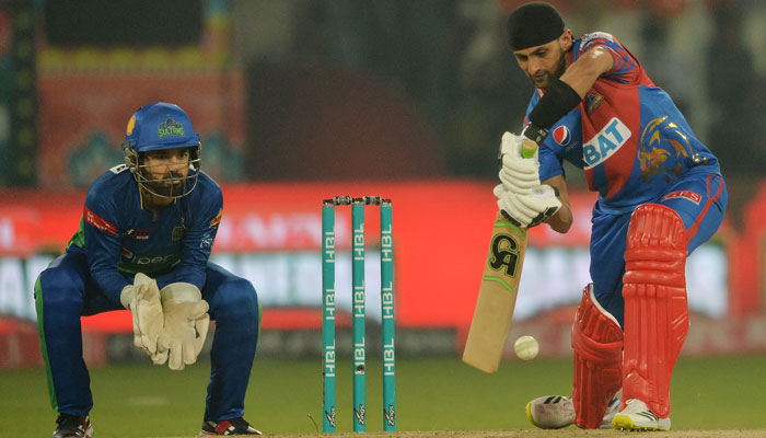 Karachi Kings Shoaib Malik (R) plays a shot as Multan Sultans captain and wicketkeeper Mohammad Rizwan watches during the PSL cricket match at the Multan Cricket Stadium in Multan on February 22, 2023. — AFP