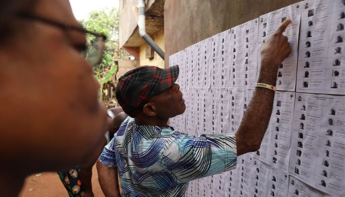 People looks for their names on voters list put up on a wall at a polling unit, during Nigerias Presidential election in Agulu, Anambra state, Nigeria February 25, 2023.— Reuters