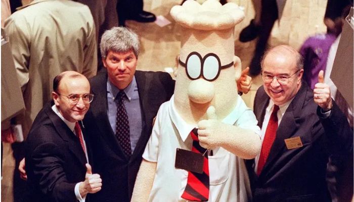Dilbert, the comic strip character struggling to make his way up the corporate ladder, is joined by William Burleigh (R), President and Chief Executive Officer of the E.W. Scripps Company, Douglas Stern (2nd from L), Pres. and CEO of United Media, and Richard Grasso (L), Chairman of the New York Stock Exchange, in giving a thumbs-up after ringing the opening bell as part of the activities to promote the launch of Dilberts new television show 25 January.— AFP/file