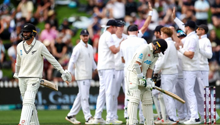 New Zealands Devon Conway (left) walks from the field after being caught during day two of the second cricket Test match between New Zealand and England at the Basin Reserve in Wellington on February 25, 2023. — AFP