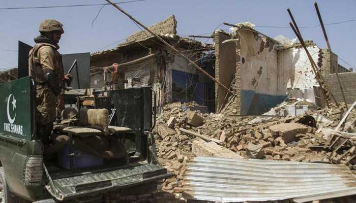 Pakistani soldiers look at a house which was destroyed during a military operation against Taliban militants, in the of town of Miranshah, North Waziristan July 9, 2014. — Reuters