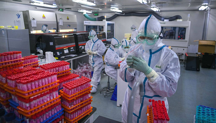 Health officials work at a laboratory in Tianjin, China.  — AFP/File