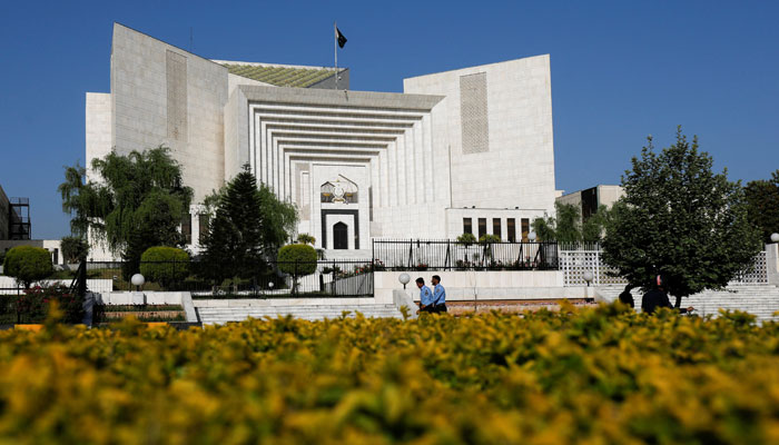 Policeman walk past the Supreme Court building in Islamabad. — Reuters/File