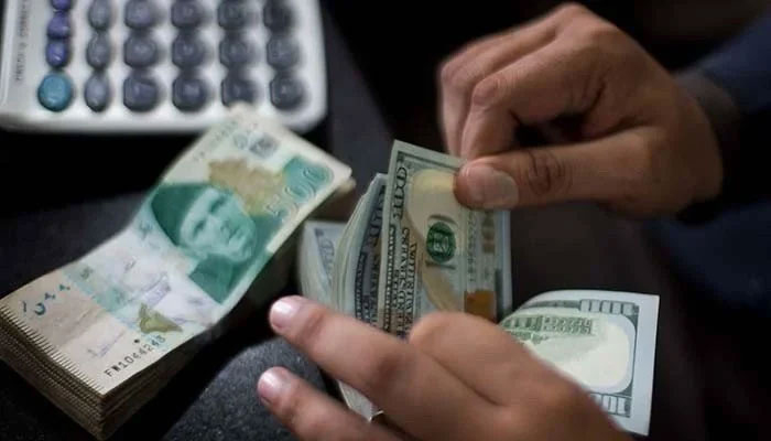 A money exchanger counts dollars. — Reuters/File