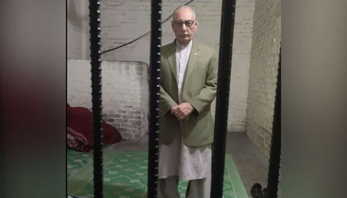 Retired army officer Amjad Shoaib was photographed in police custody. Twitter