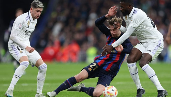 Real Madrids German defender Antonio Rudiger (R) vies with Barcelonas Dutch midfielder Frenkie de Jong during the Copa del Rey (Kings Cup) semi final first leg football match between Real Madrid CF and FC Barcelona at the Santiago Bernabeu stadium in Madrid on March 2, 2023. AFP