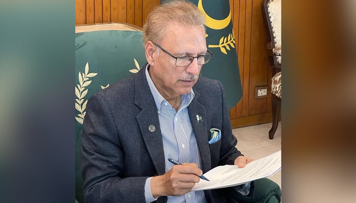 President Arif Alvi is signing the advice sent to him from the  Election Commission of Pakistan at the Presidents Secretariat in Islamabad on February 3, 2023. — Twitter/@PresofPakistan