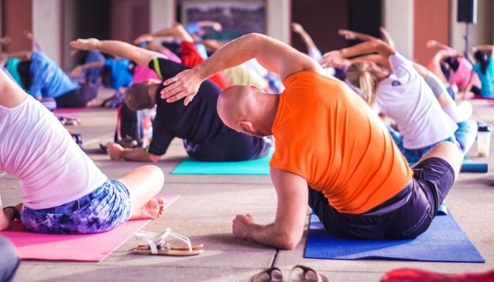 Image shows people doing yoga.— Unsplash