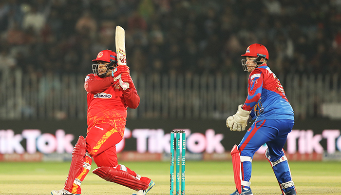 Azam Khan hits a shot as the Karachi Kings wicketkeeper looks on during the 19th match of the eighth edition of the Pakistan Super League (PSL) in Rawalpindi on March 3, 2023. — PSL