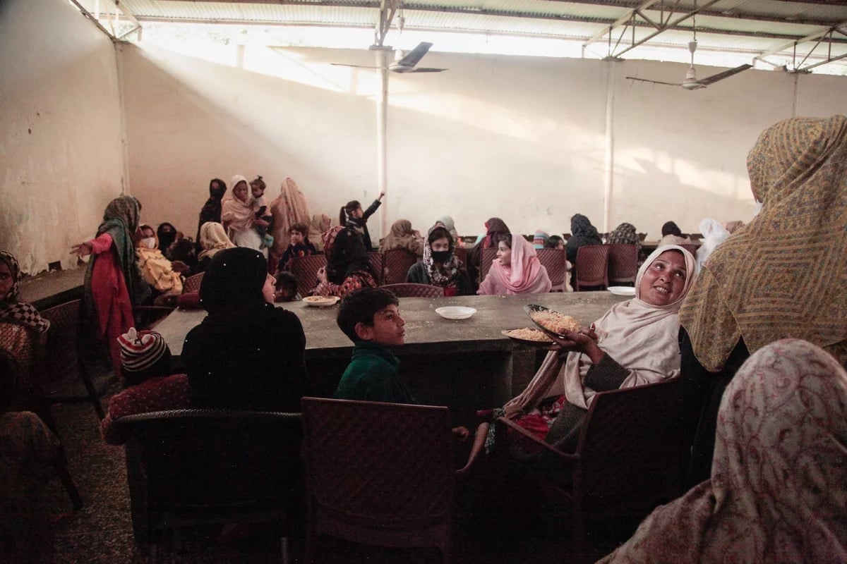 Women sit in a gender-segregated hall, waiting to be served free food cooked in open-air stalls surrounding the shrine to the Sufi saint Bari Imam.— NPR