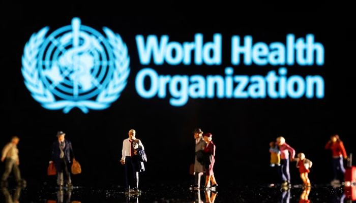 Small figurines are seen in front of the displayed World Health Organisation logo in this illustration taken on February 11, 2022. — Reuters