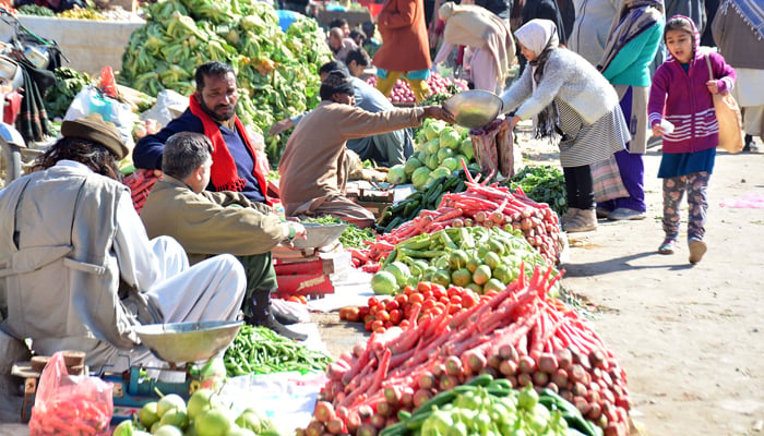 Vendors are selling vegetables at Sunday Weekly Bazaar in the Committee Chowk area in Rawalpindi. — Online/File